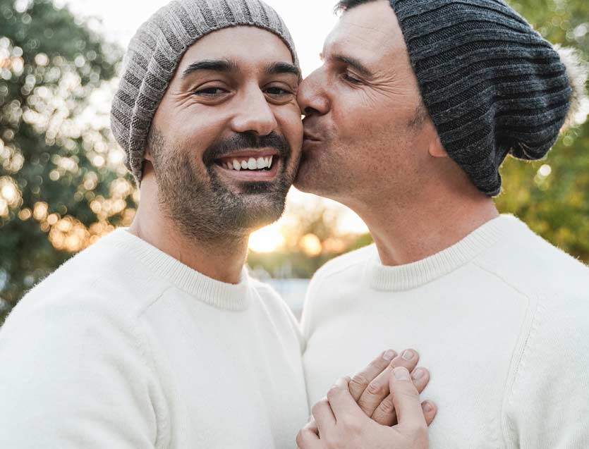 Mature gay men couple having tender moment outdoors