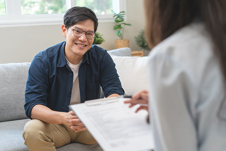 Asian American man in trauma counseling session