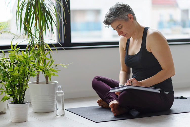 Contemplative LGBTQ woman journaling