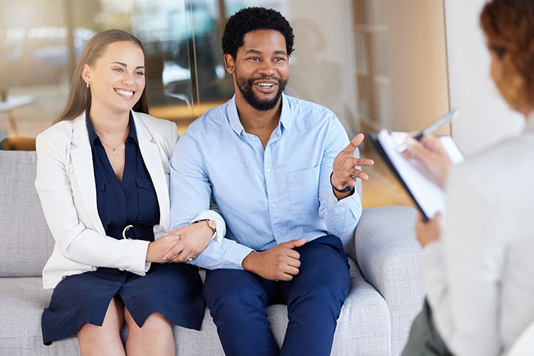 A man and woman meeting their couples counselor