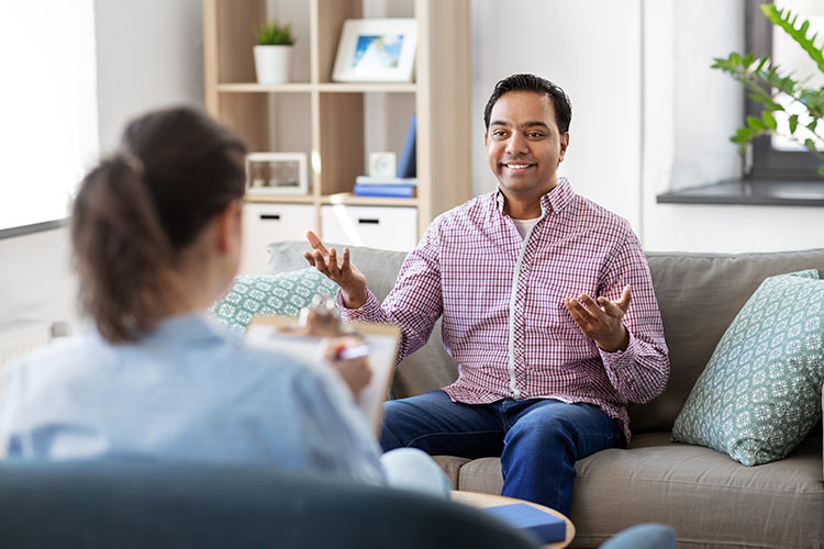 South Asian American man in therapy experiencing an "aha" moment