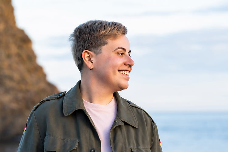 Non-binary person smiling
