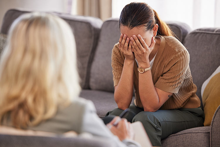 Woman on therapy couch crying