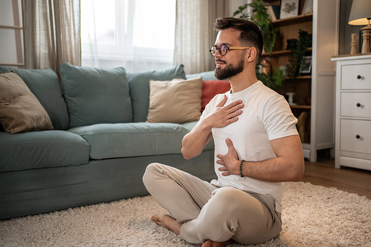 Young man with glasses practicing mindfulness