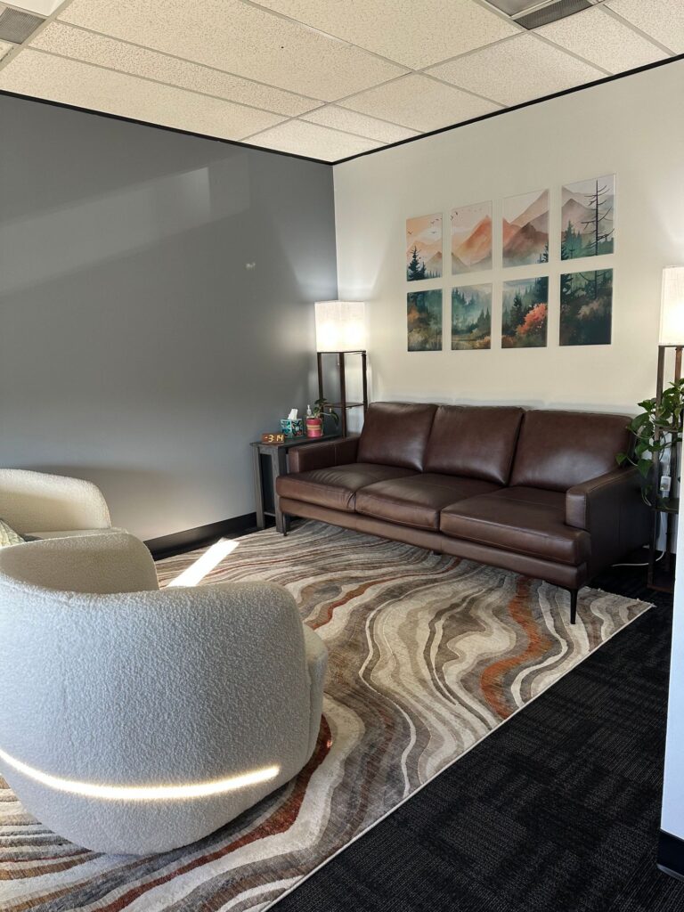 Therapy room with comfortable seating at Embraced Therapy in Denver, Colorado
